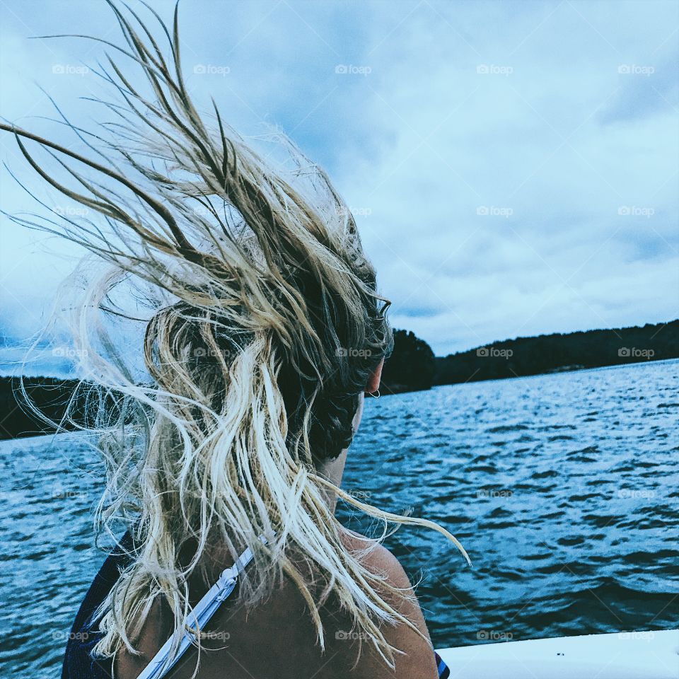 Hair flying while looking at the lake views 