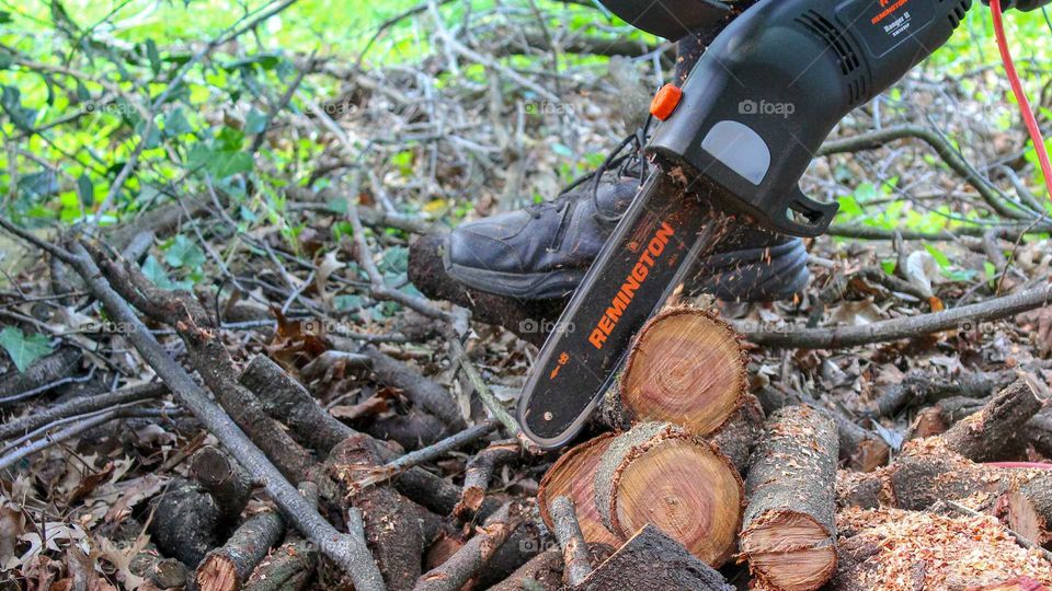 Cutting logs with a Remington electric chainsaw