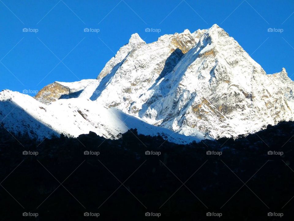 Snowy mountain against clear sky