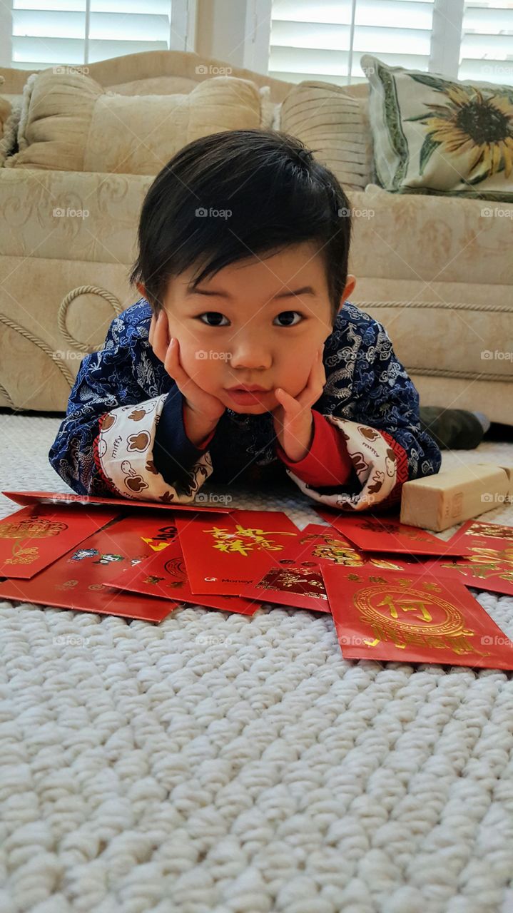 Portrait of asian boy lying on carpet