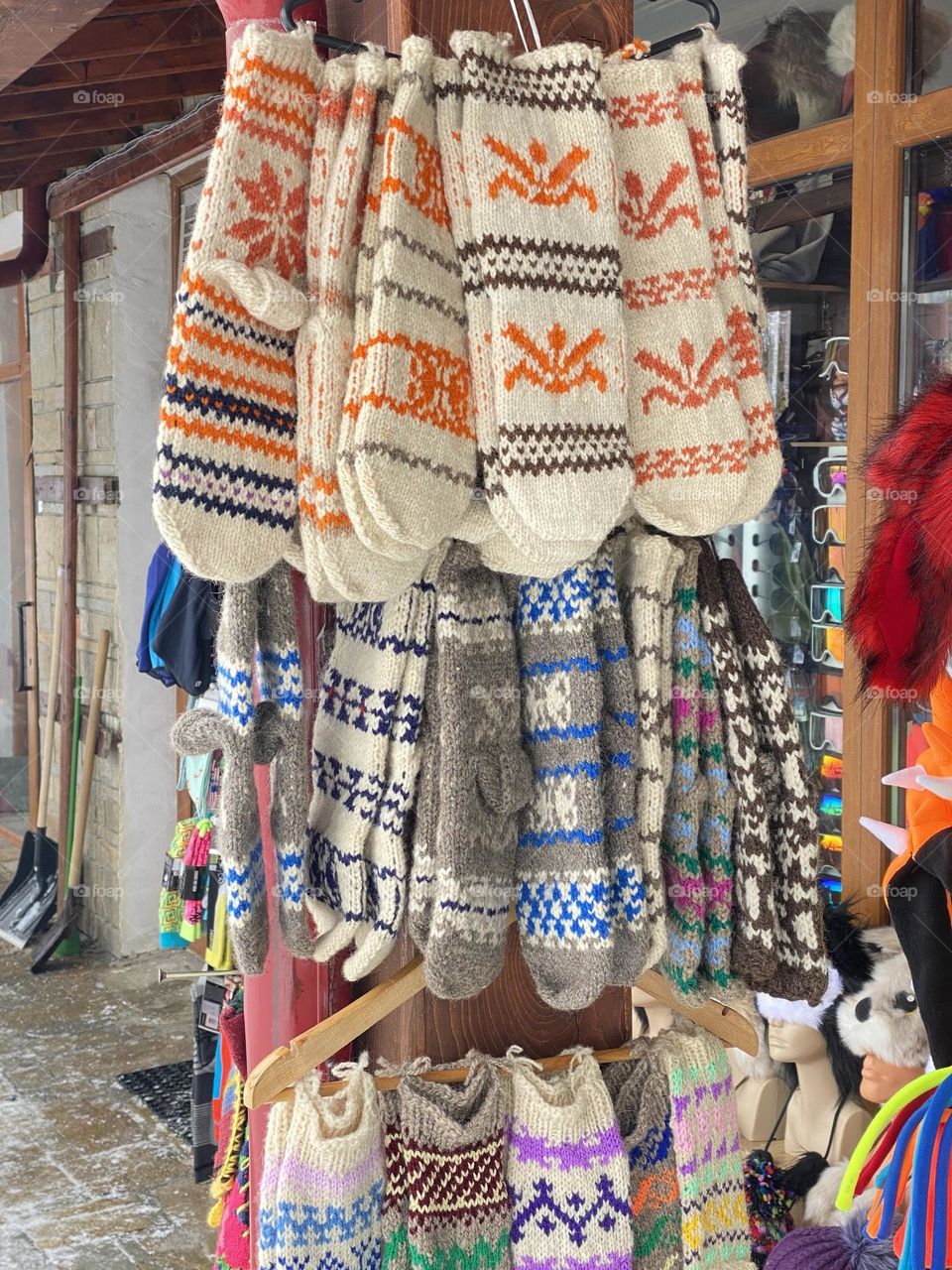 Traditional hand knitted colourful socks handing on a stall 