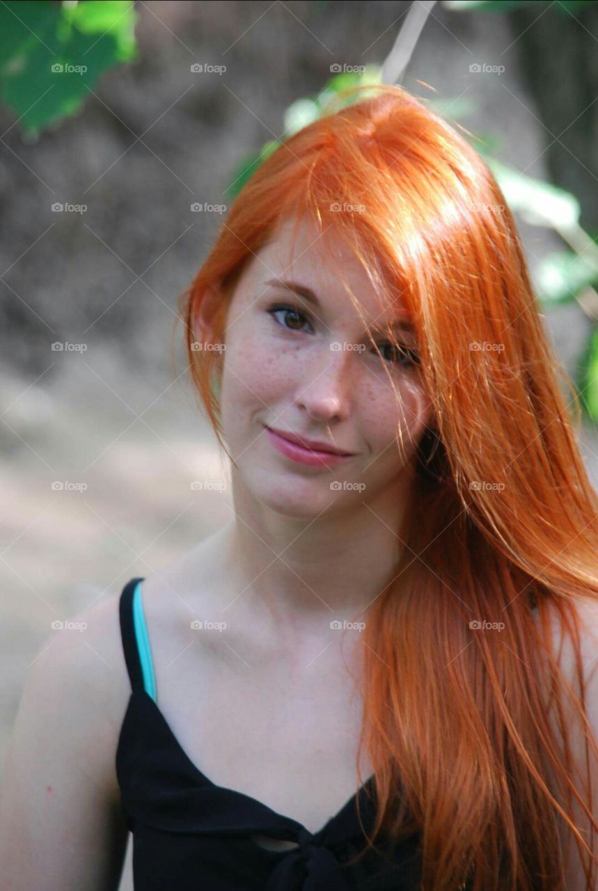 beautiful redhead woman in the woods