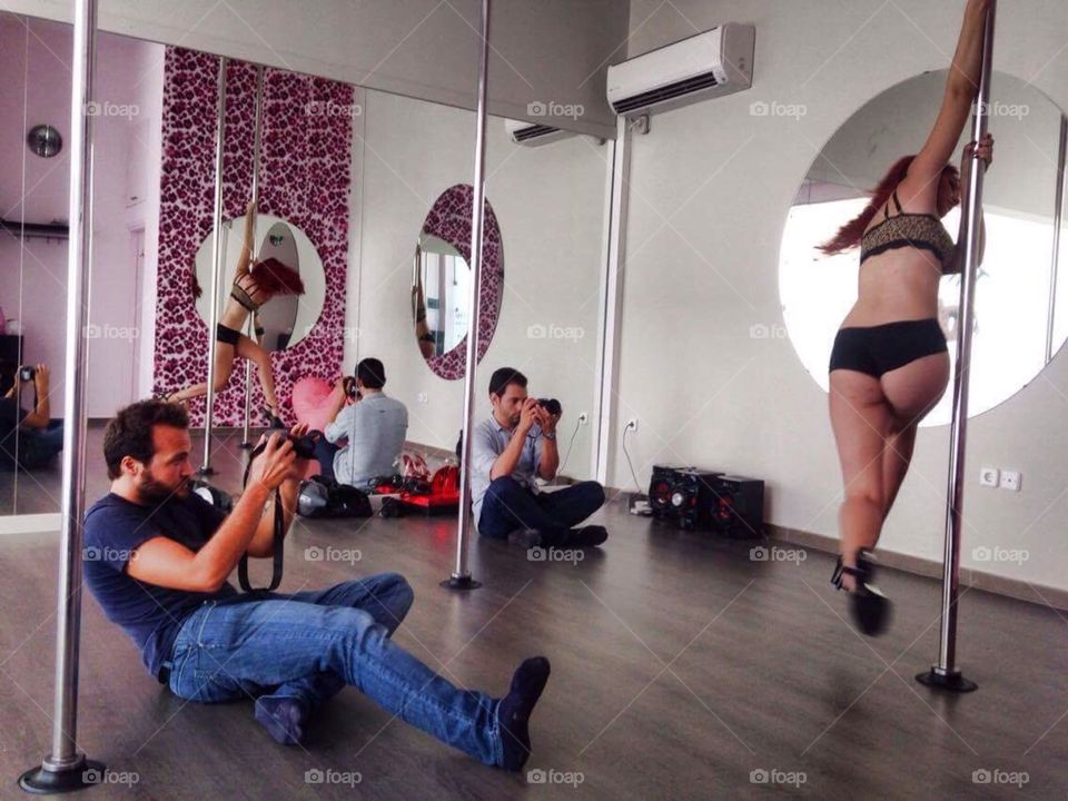 Photographer's taking pictures of pole dancer