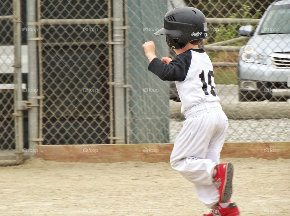 Young Baseball Player. Young Boy Running The Bases
