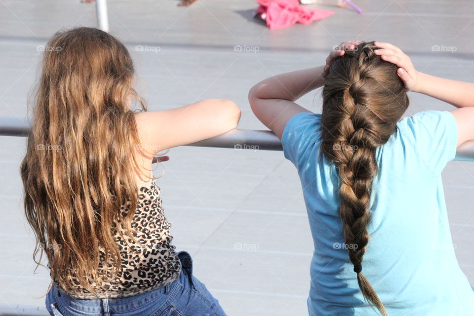 Football fans in the making. Two girls watching a football game