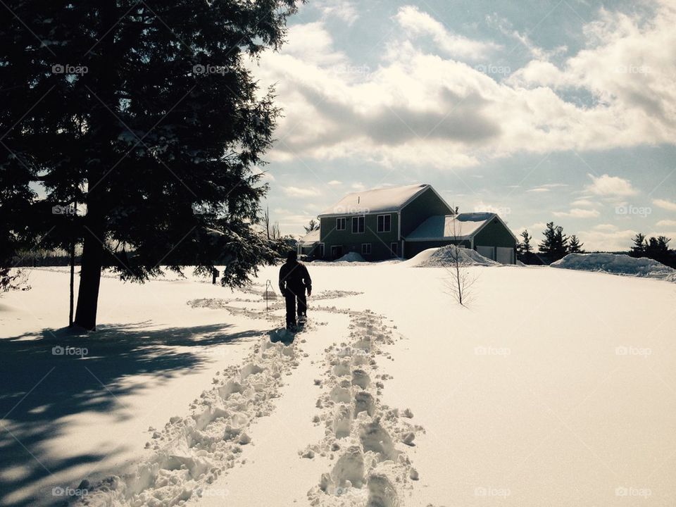 Rear view of person walking in snow
