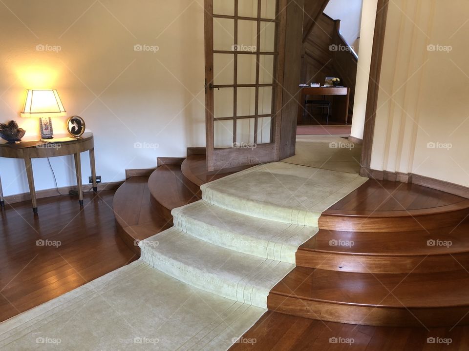 Interior decor and elegant stairway of a gentleman’ home, with the emphasis on a bid to impress.