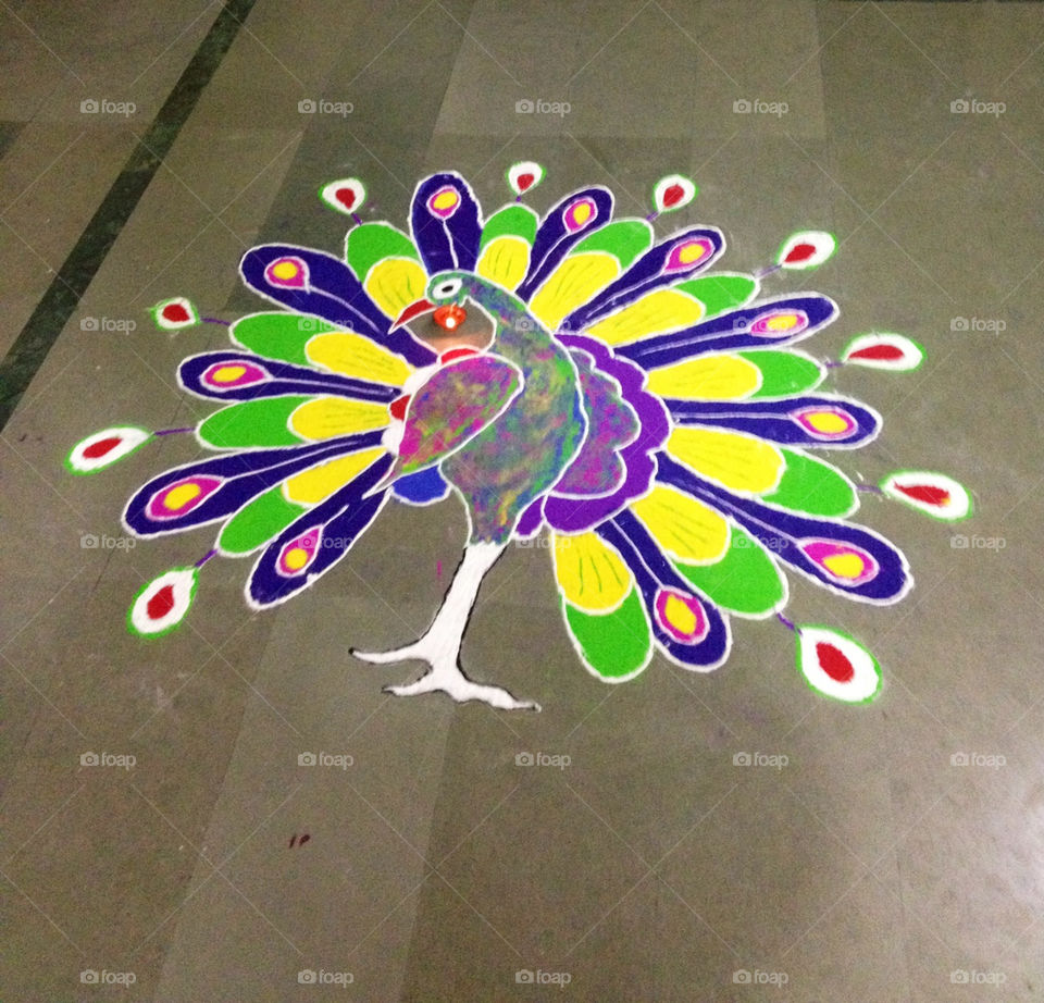 the colourfull drawing made by dry colours this art is called rangoli made by dry colours on floor this art name is rangoli by hitmancool