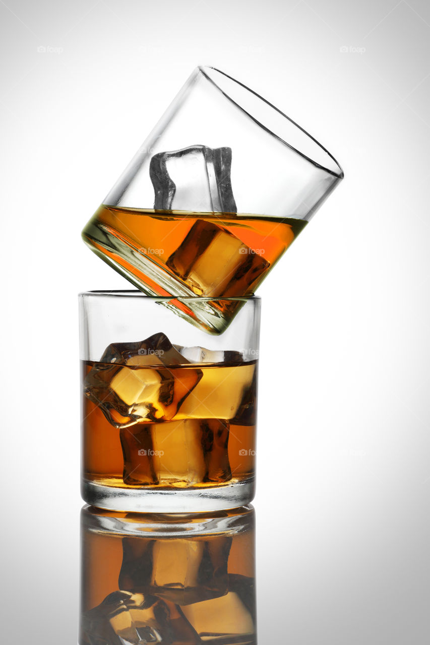 Chilled Whiskey Rum glasses with ice cubes