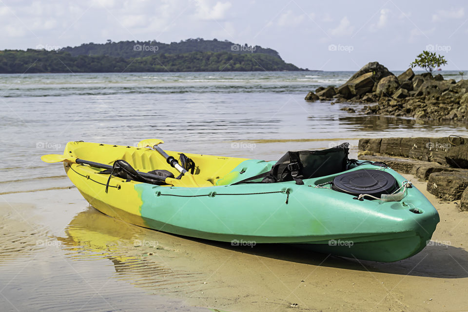 Kayaking on the sand of the sea background mountains and rocks.