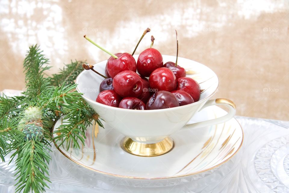 Elevated view of cherries in tea cup