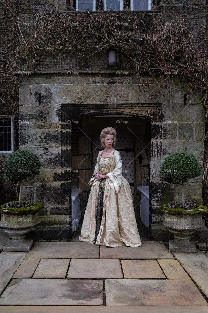 One of a set of photos taken in a 17th century house that is now a restaurant and hotel. The look is based around Marie Antoinette with long luxurious dress and hair styled high. Makeup was very pale and finished using baby powder