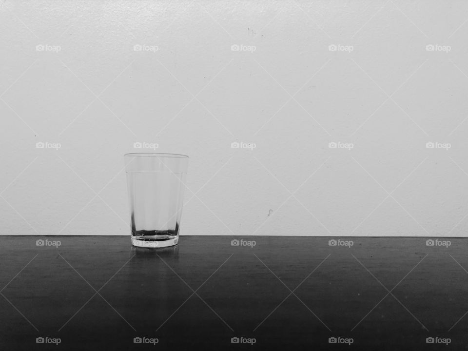 Minimalist black and white... a small glass in a table.