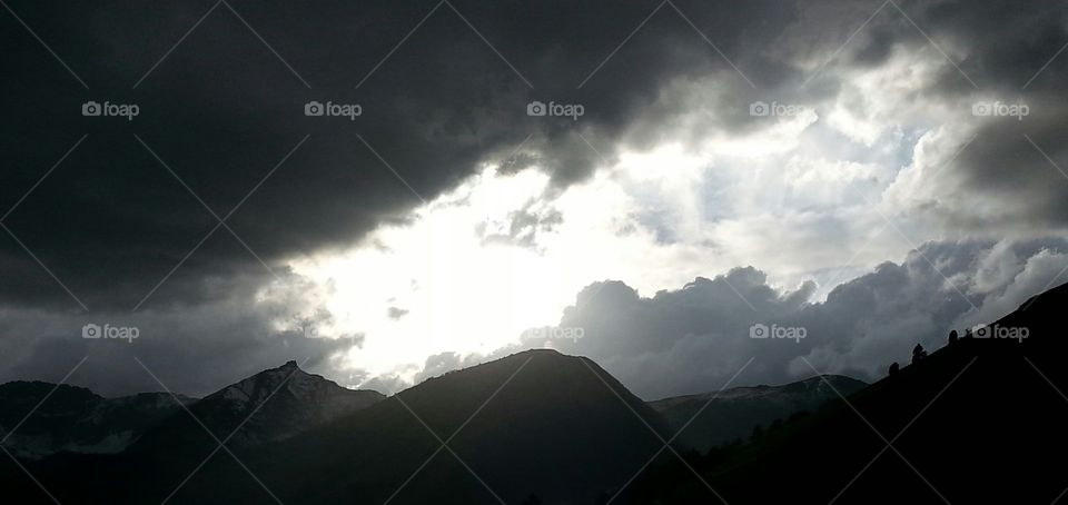 The Passing Light. a beautiful light highlight s the passing clouds over the mountains.