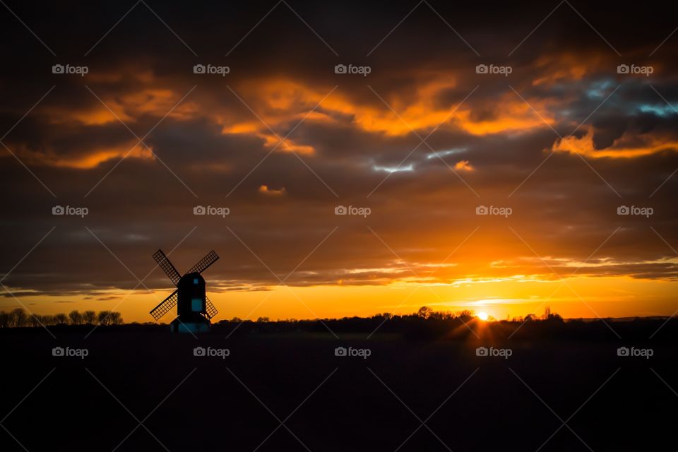 Silhouette of windmill at sunset