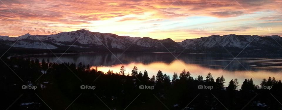 sunset snowy peaks. picture of sunset over lake tahoe