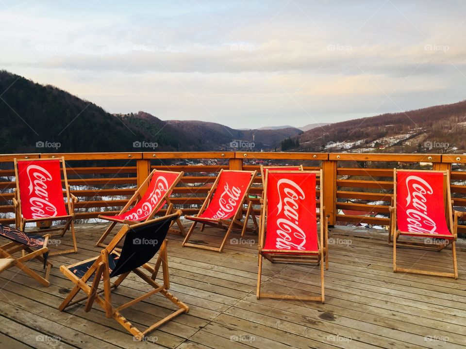 Coca Cola relaxing chairs with sky in the background 