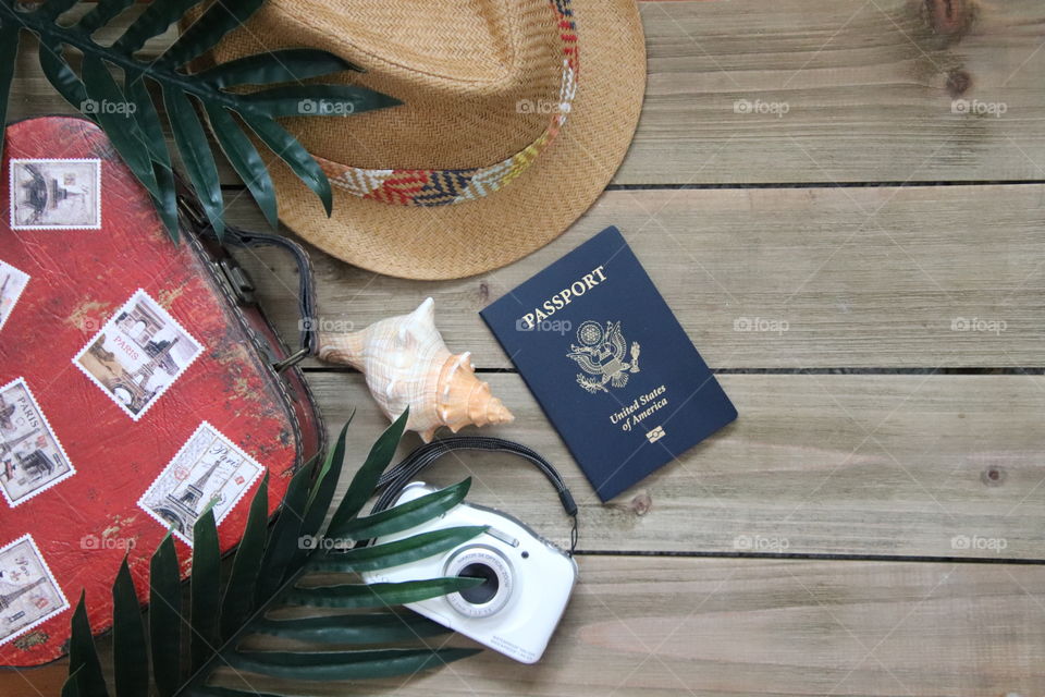 Flat lay of travel items with wooden background 