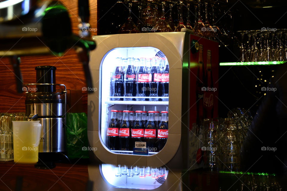 coca-cola bottles in the fridge with glass window