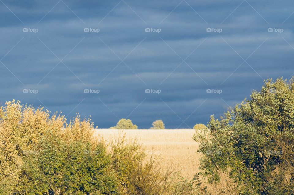 Sunlight illuminating the countryside against a threatening sky