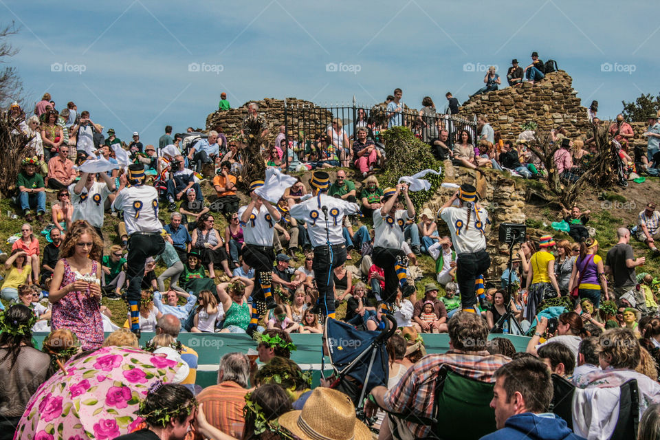 Morris dancers perform on stage in front of a large crowd at Hastings Traditional Jack in the Green, U.K. 2008