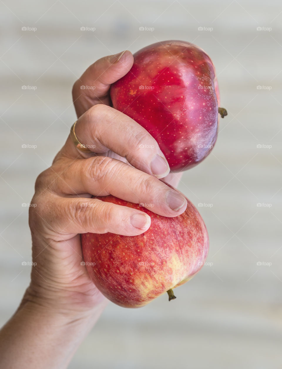 Two red apples in human hand
