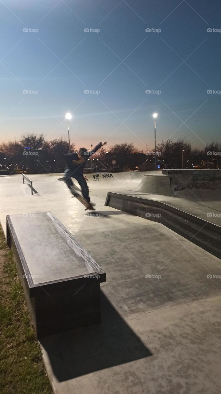 Skateboard tricks almost in the night roller park