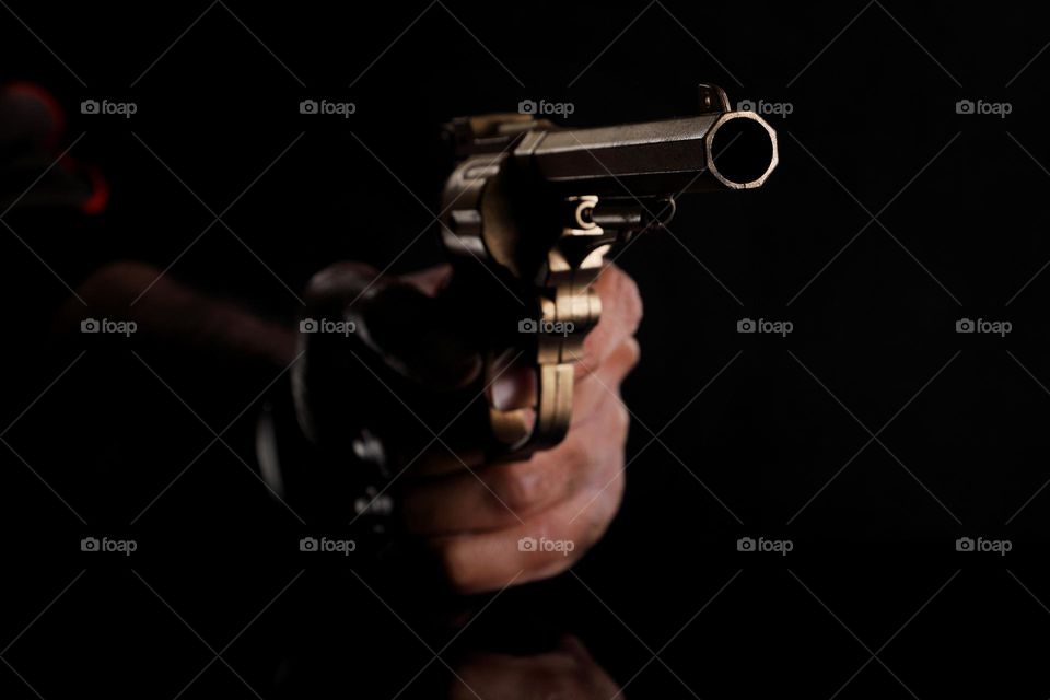 gun in a hand - crime concept
