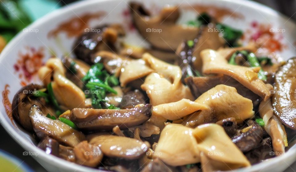 Home cooked abalone and shiitake mushroom stew. The abalone is fashioned into bite sized ribbons. Stew base is soy sauce.