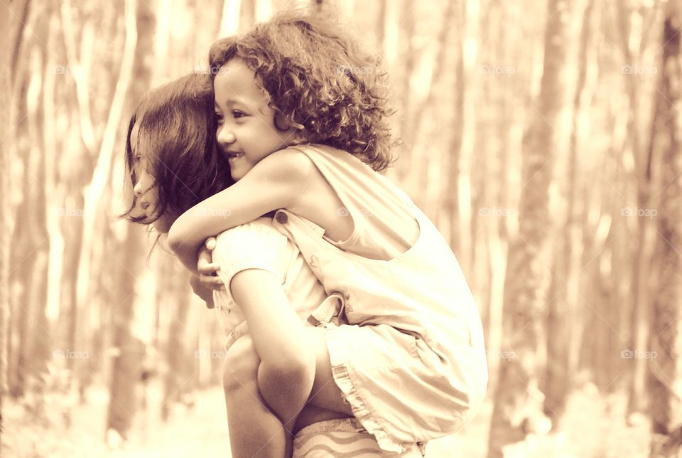 Girl giving piggyback ride to her sister
