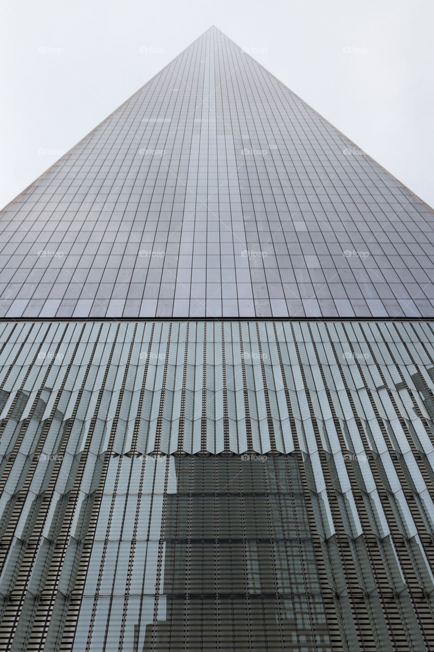 Looking up at the top of a modern skyscraper 