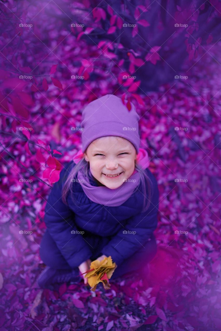 Smiling girl in purple nature 
