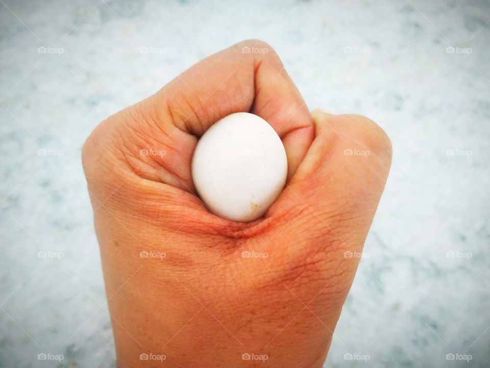 Fist Stone
It is a hand, it has a fist and a white colored stone inside the fist