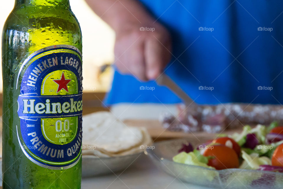 Having a cold Heineken while cooking 