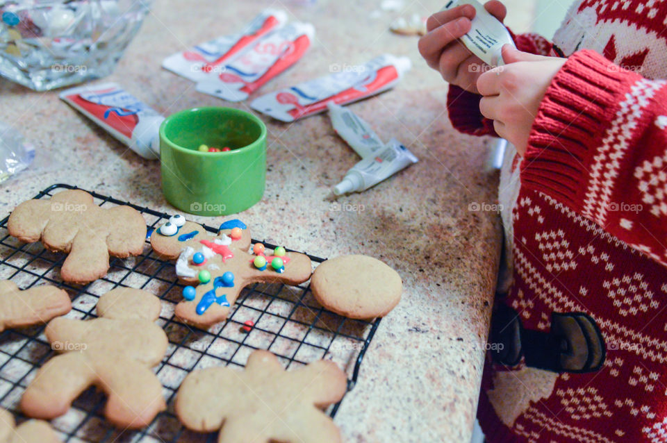 Child decorating Christmas cookies