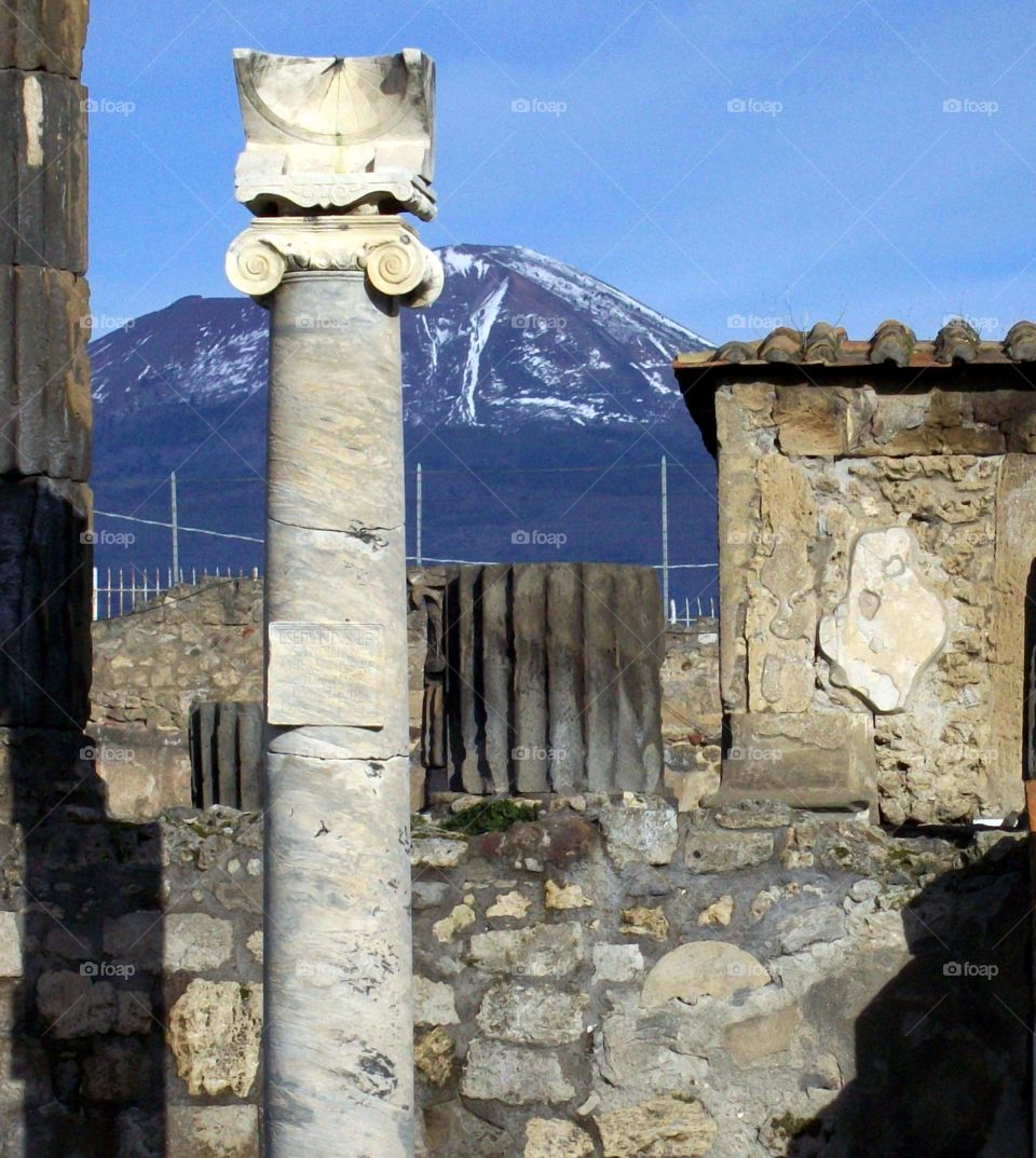 Ruins of Pompeii with exquisite shadows and Mount Vesuvius beyond 