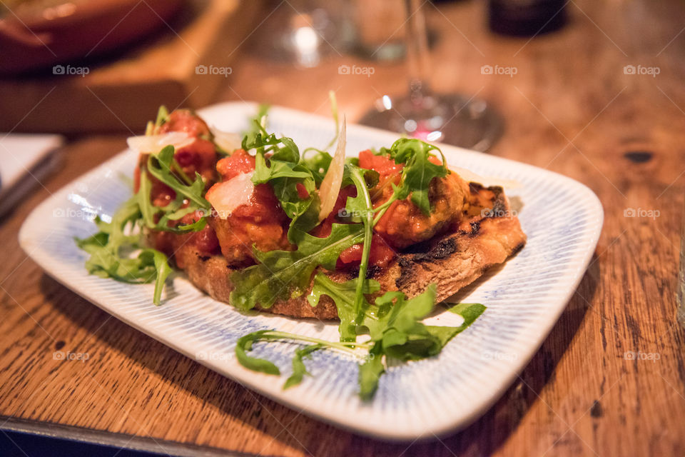 Starter atfamous Jamie's Italian restaurant in London. Starter with toasted bread and meatballs. The restaurant has it's name after world famous TV chef Jamie Oliver.