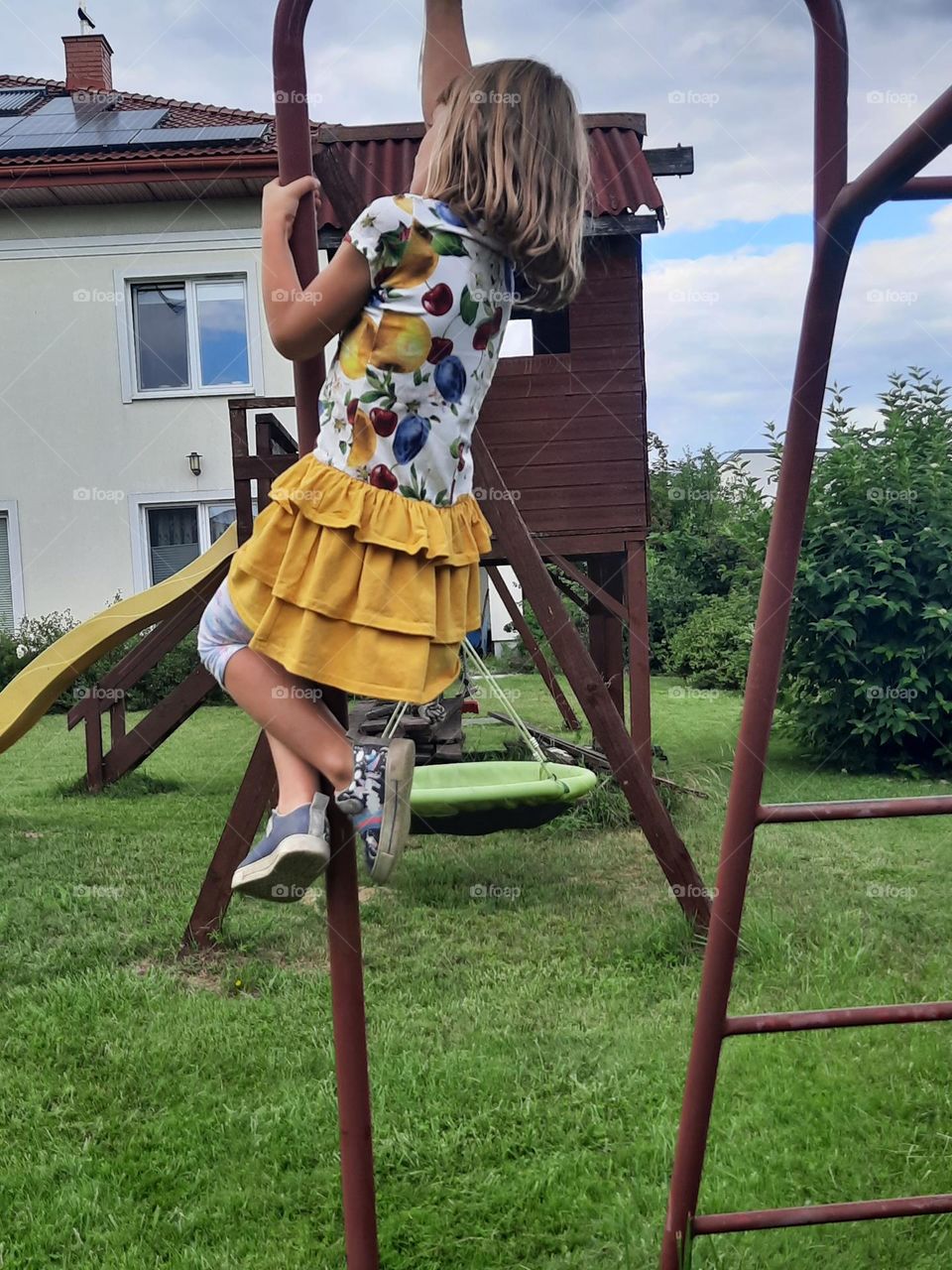 little girl in summer outfit  on playground