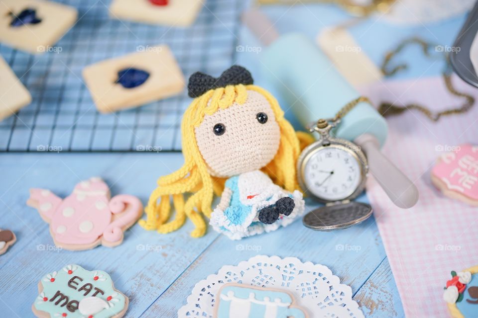 Cute crochet doll of Alice in Wonderland, pocket watch and sugar cookies.