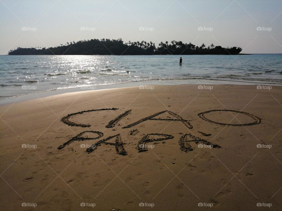 'goodbye Dad' written on Sand at sunset