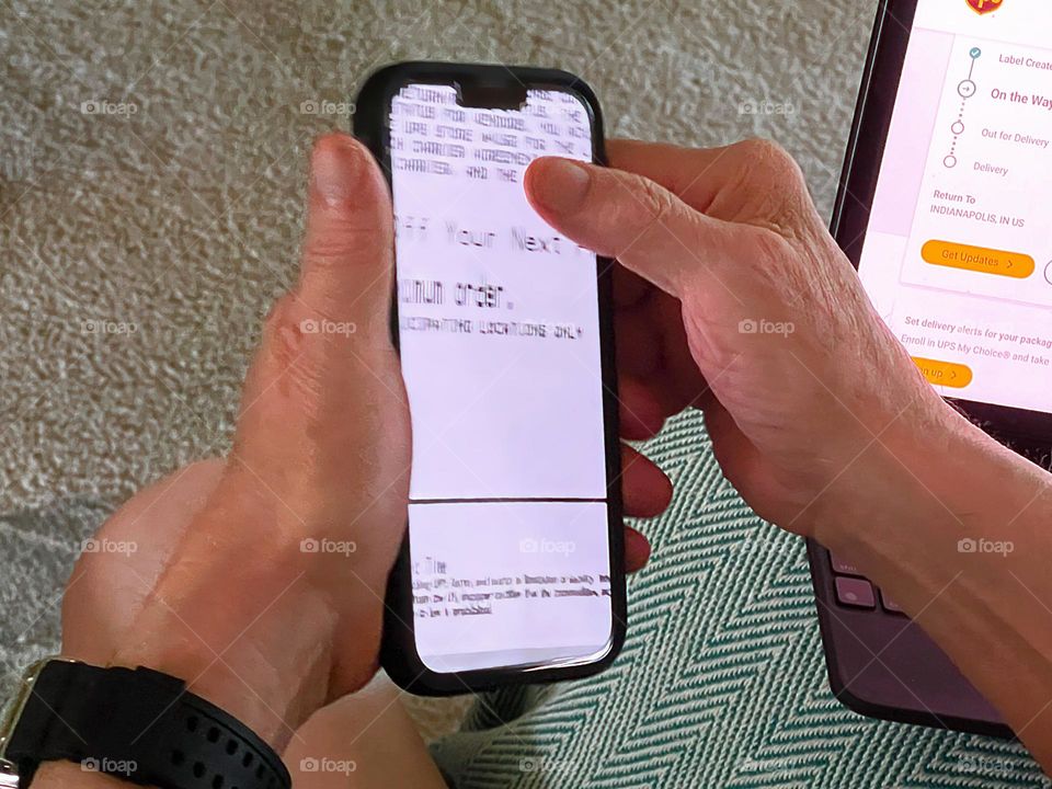 Man’s hands using cellphone.