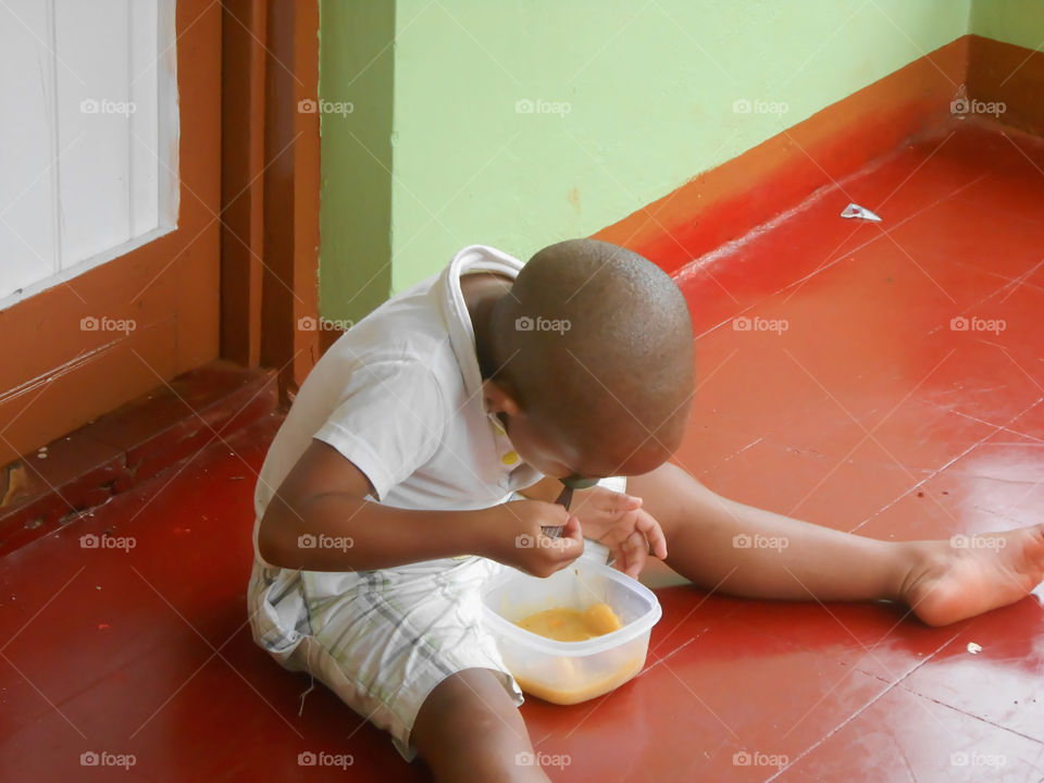 Sitting on the Floor Eating From a Bowl