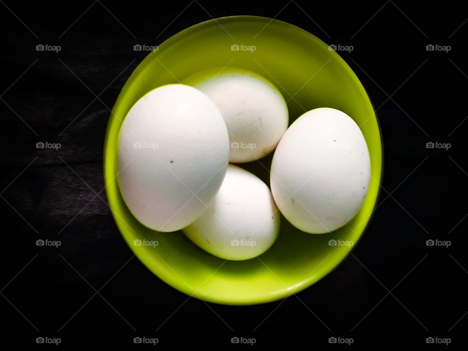 Title-Egg Donald
Description- Photo of 4 eggs in a bowl captured on black background