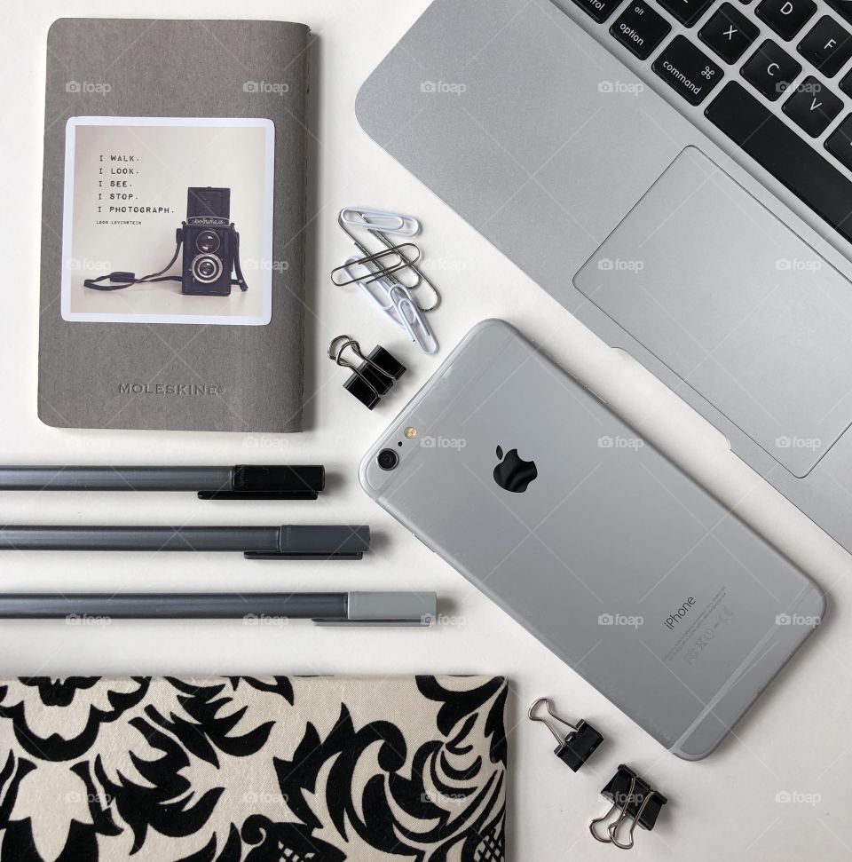 Gray, black and white flat lay with technology and office supplies for a photographer
