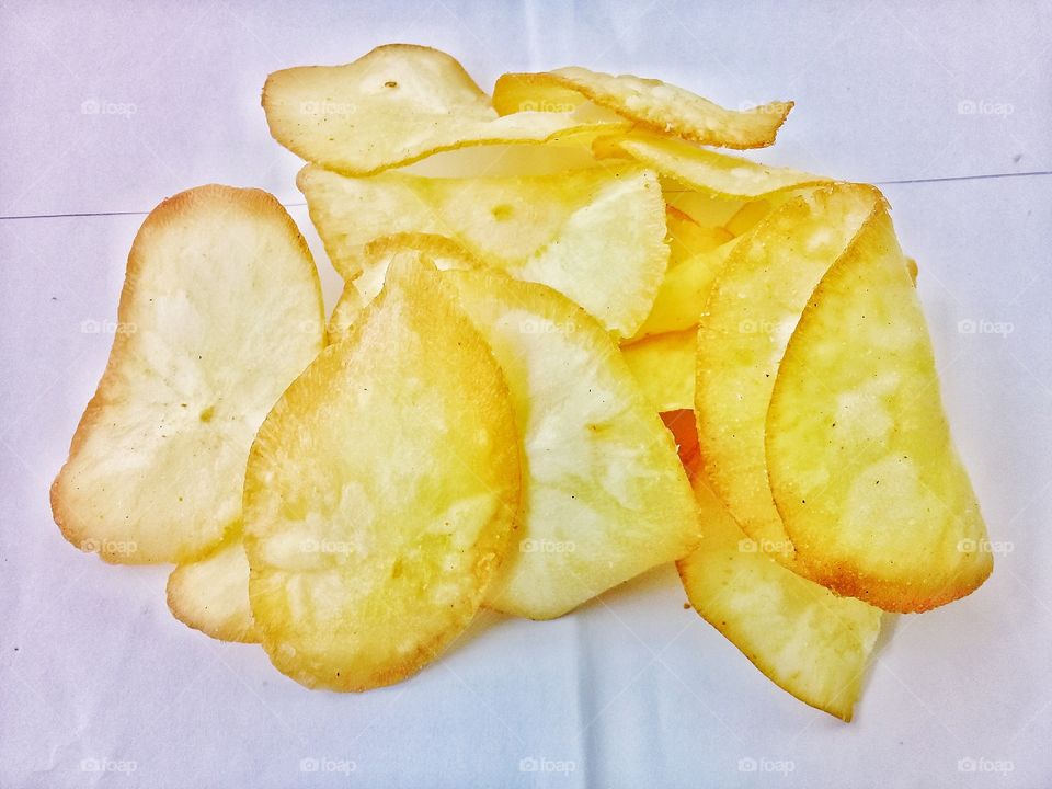 Cassava chips.this food is made from cassava which is peeled and thinly sliced mixed with various herbs and then fried