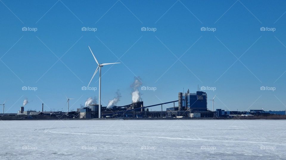 Outokumpu Oyj Steel factory in Tornio, Finnish Lapland. Windmills by the se making electricity.