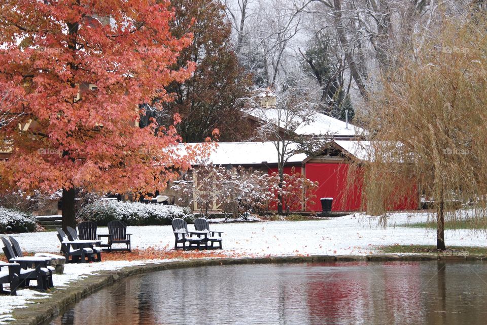 Red barn and pond with fresh fallen snow