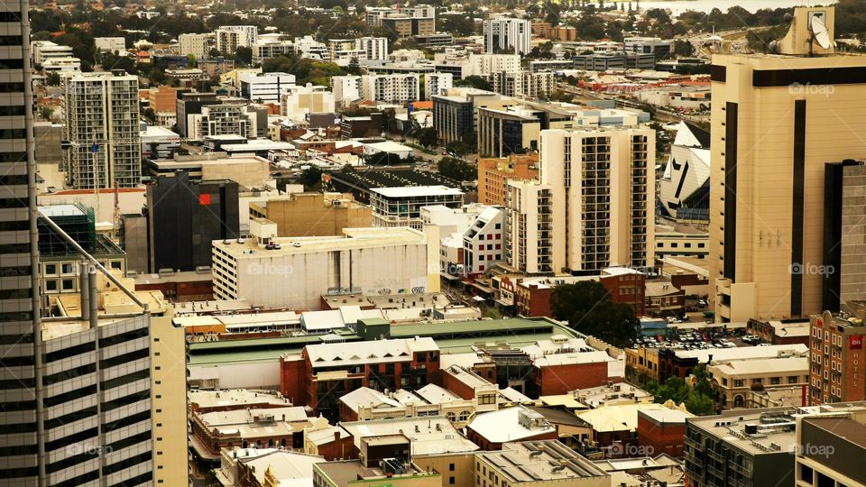 looking down over the streets and building from a high rise sky scraper tower building in Perth, Western Australia