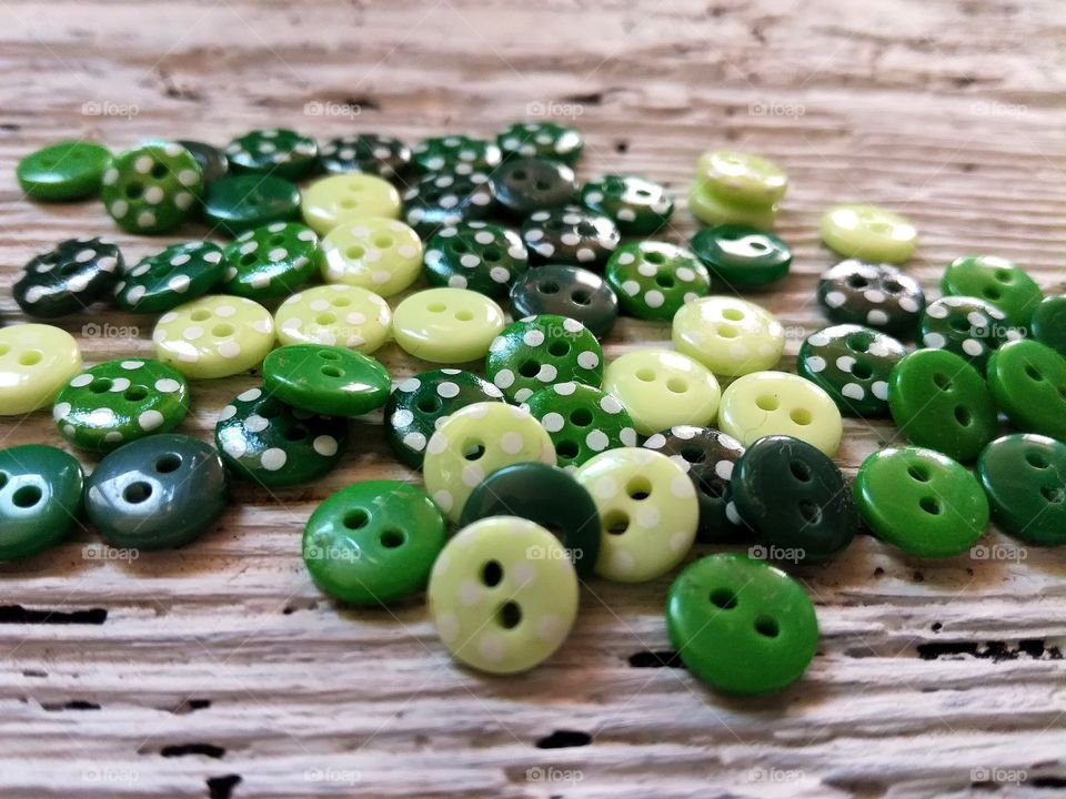 Green buttons on wood