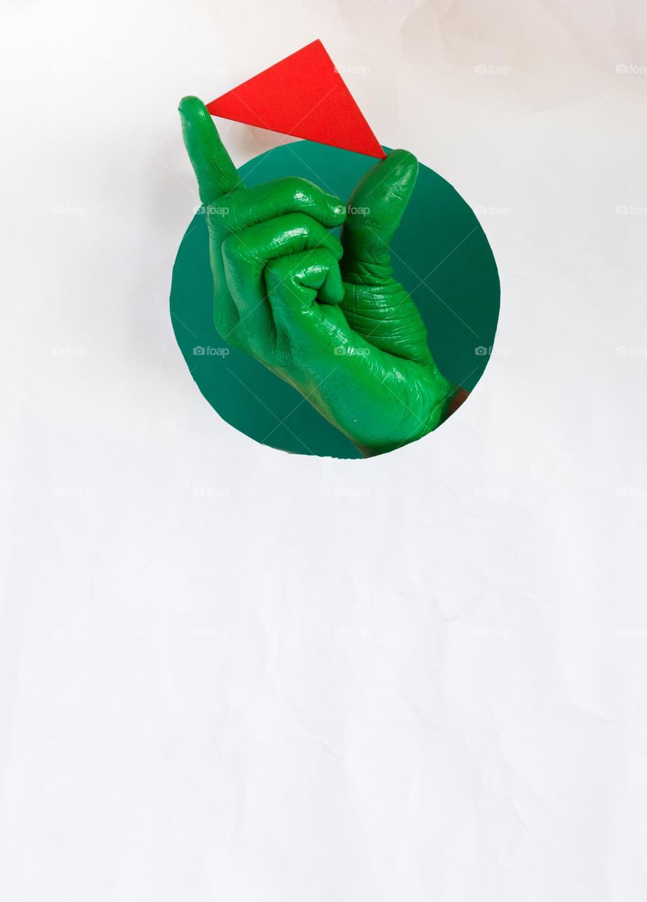 Green hand holding red triangle.